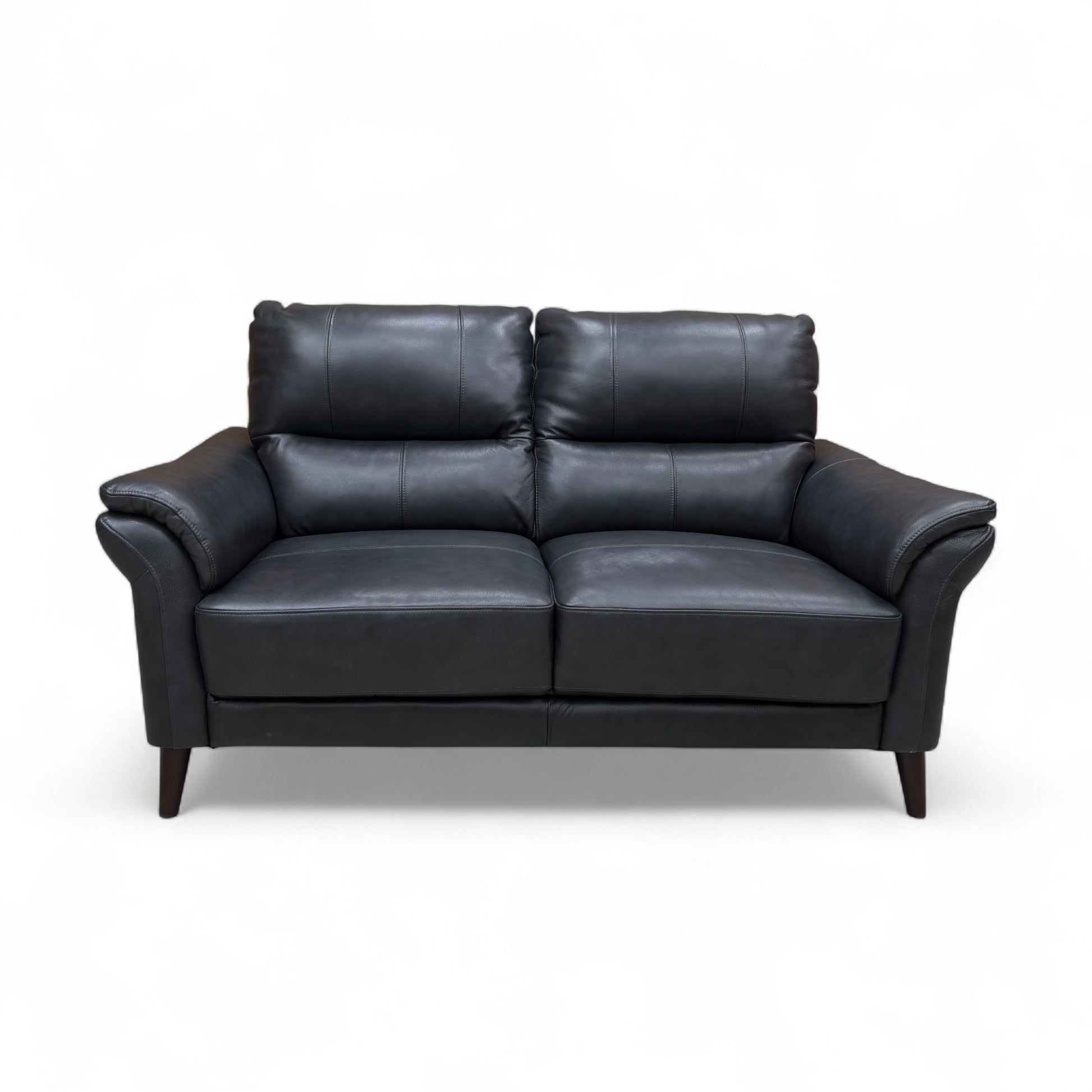 Full front view of the ‘Winner’ Montana 2 Seater Sofa in rich navy leather, showcasing the rolled arms and two seat cushions.