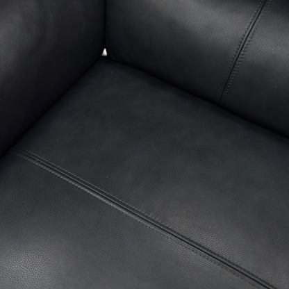 A close-up shot focusing on the seat cushion, the pocket spring detail, and the buttery-soft navy leather texture.