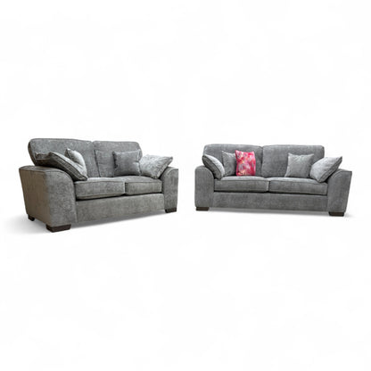 Angled view of the large 'Harvey' 3-seater sofa in charcoal grey chenille fabric, showing the modern cushion back and English arm style.