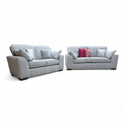 Angled view of the large 'Harvey' 3-seater sofa, showcasing the modern English arm style, deep seat cushions, and the light grey chenille fabric.