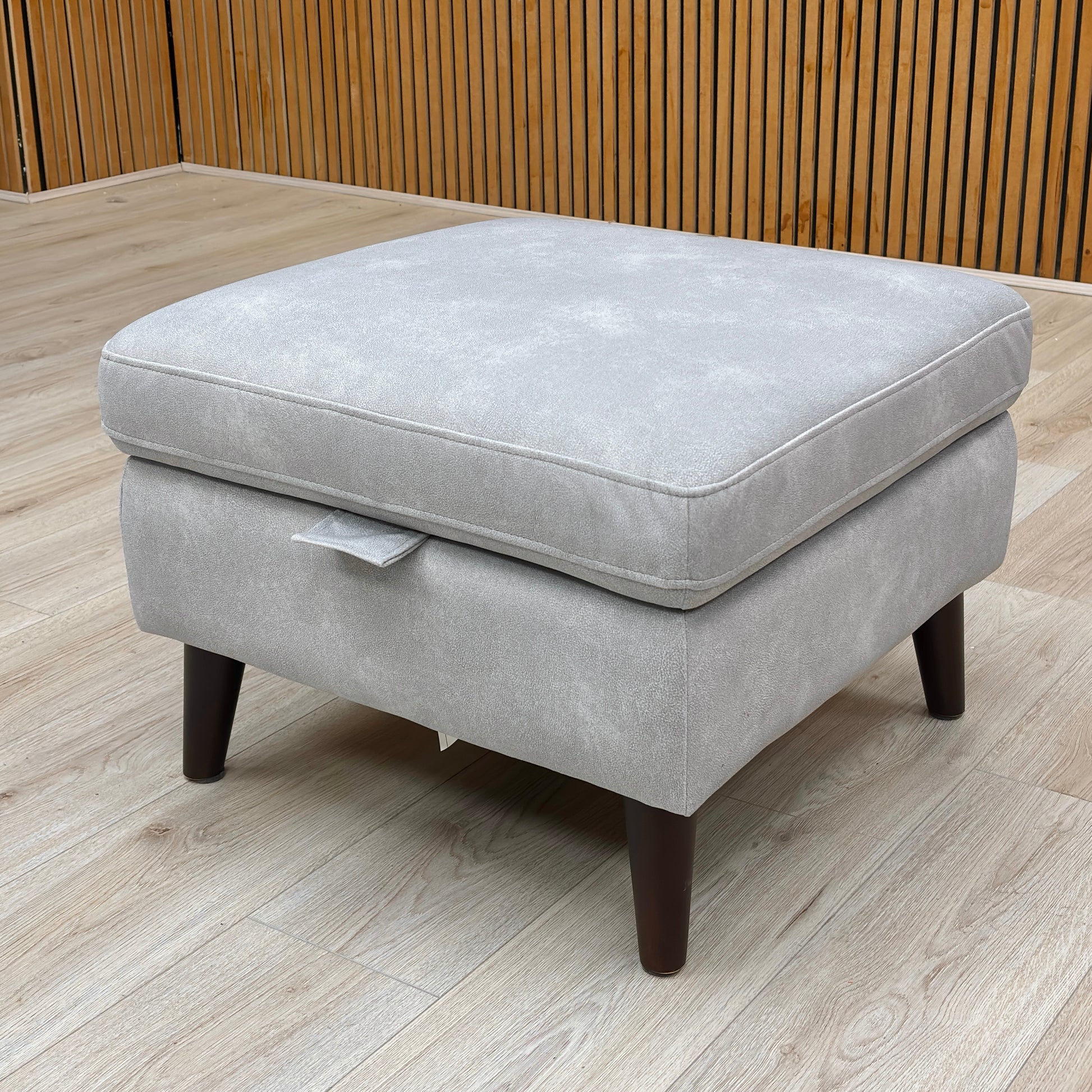 Lifestyle shot of the Morgan footstool highlighting the plush velvet upholstery and clean mid-century silhouette.