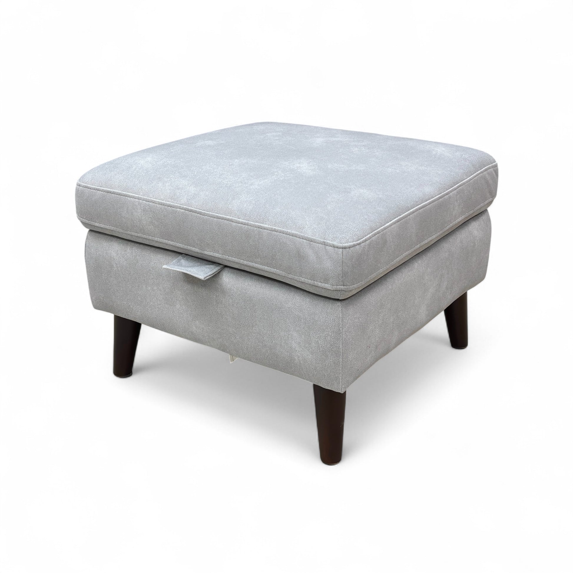 A shot of the footstool's base, clearly showing the removable metallic tapered legs.