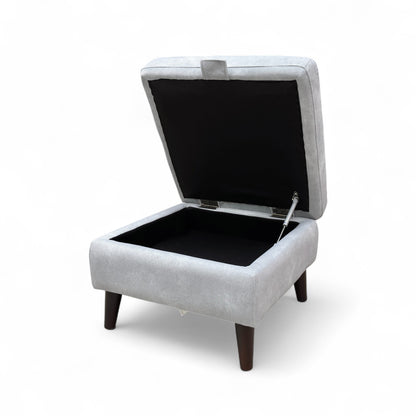 The footstool shown with the lid removed, placed beside the base to display the empty storage area clearly.