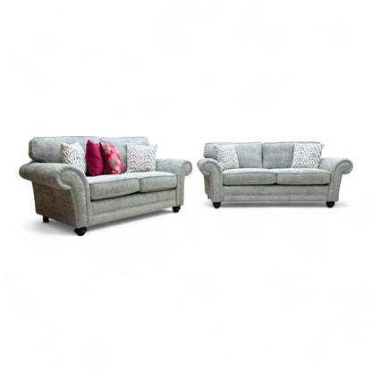 Full, straight-on view of the 'Clara' 3-seater sofa in sage green woven fabric, highlighting the cushion back design and wooden feet.