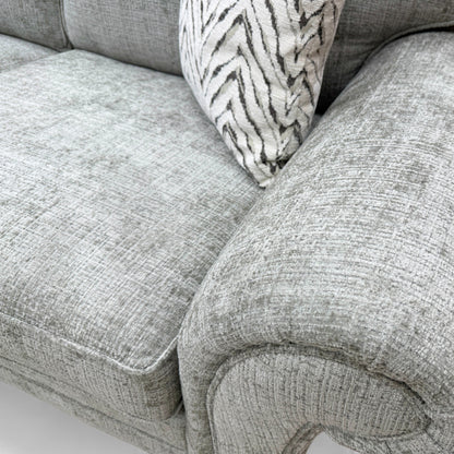 Close-up texture detail of the sage green woven fabric on the 'Clara' sofa, showing the material's weave.