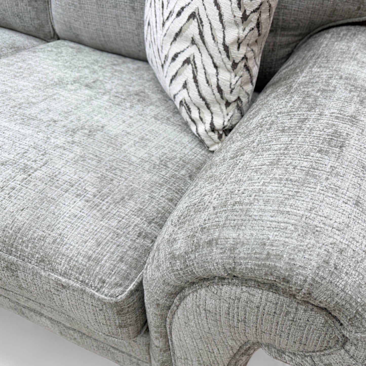 Close-up texture detail of the Sage Green Woven Fabric upholstery on the 'Clara' sofa, showcasing the tight weave and soft green hue.