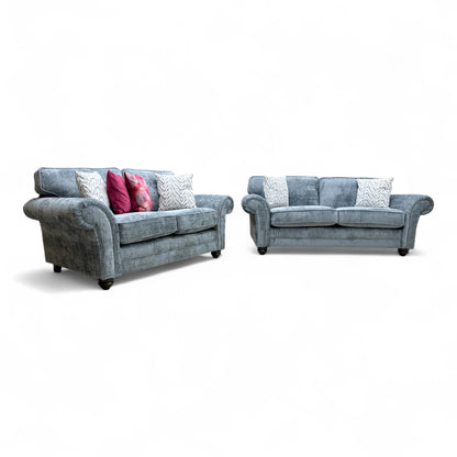 Full, straight-on view of the 'Clara' 3-seater sofa in bluish-grey woven fabric.