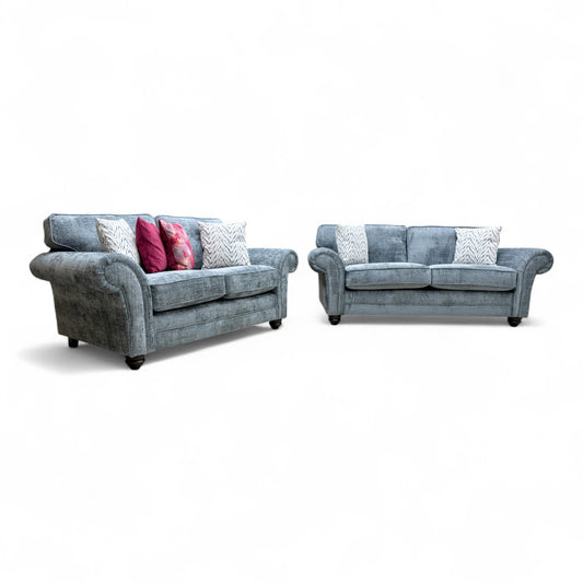 Full, straight-on view of the 'Clara' 3-seater sofa in bluish-grey woven fabric.