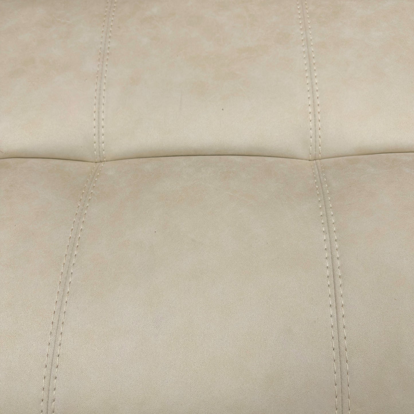 Detail shot focusing on the lower part of the footstool, showing the wooden or subtle feet/base.