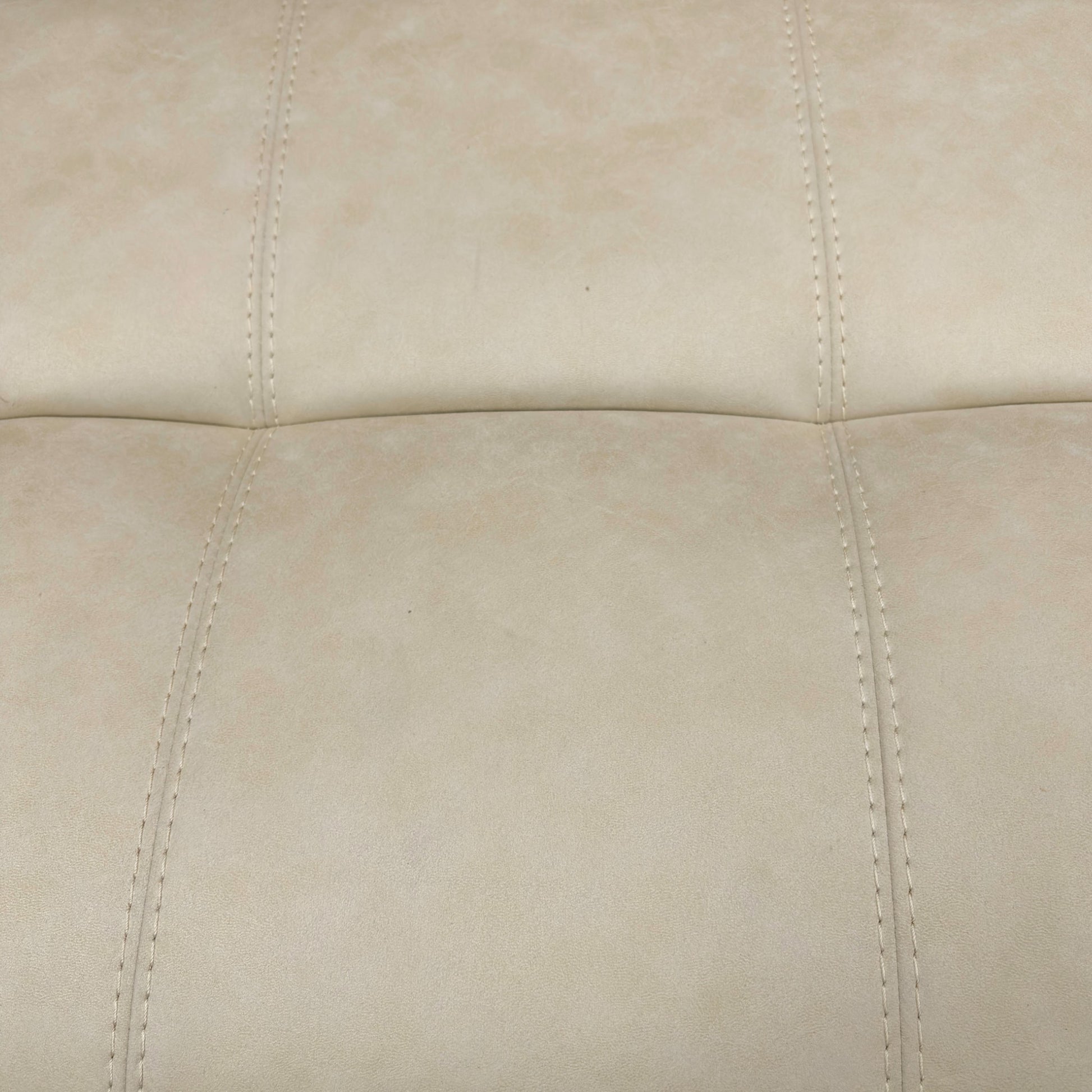 Detail shot focusing on the lower part of the footstool, showing the wooden or subtle feet/base.