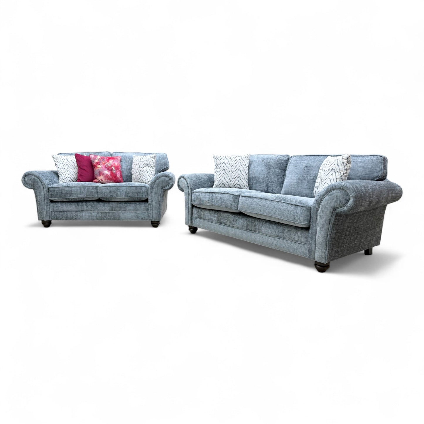 Detailed view of the scroll arm, comfortable back cushions, and seating area on one of the 'Clara' sofas.