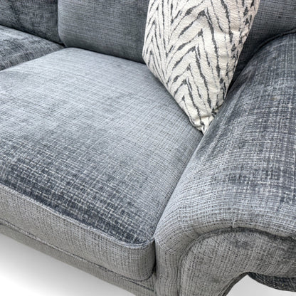 Close-up texture detail of the Bluish Grey Woven Fabric upholstery on the 'Clara' sofa, showing the weave and slight blue tint to the grey color.