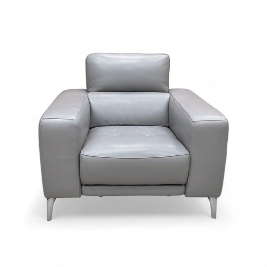 Full front view of the New York Armchair in Shale Grey leather, showcasing its modern shape and generous cushioning.