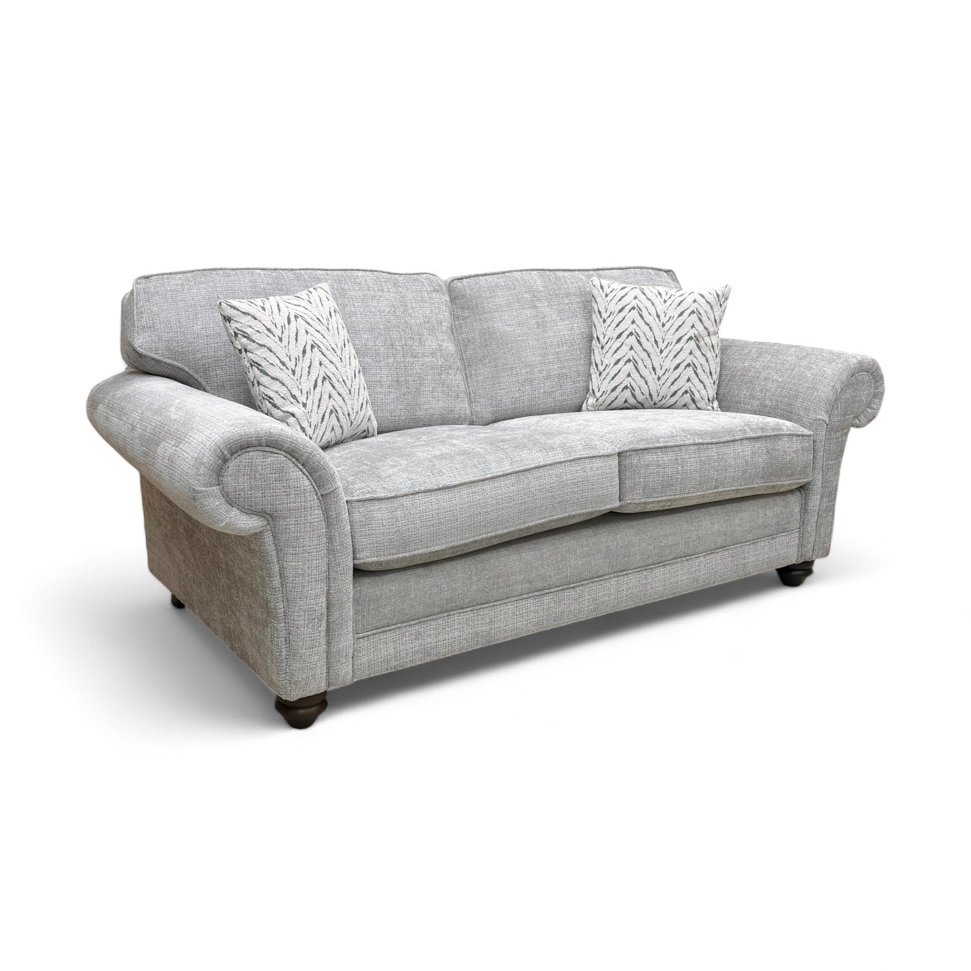 An angled side view of the sofa, highlighting the texture of the silver woven fabric and the shape of the elegant scroll armrests.