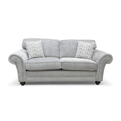 Full front view of the ‘Clara’ 3 Seater Sofa in silver woven fabric, showcasing the cushion back and scroll arms.