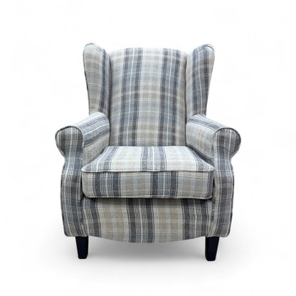  front view of the 'Shirley' armchair, highlighting the high back, scroll arm design, and the subtle checkered pattern of the fabric.