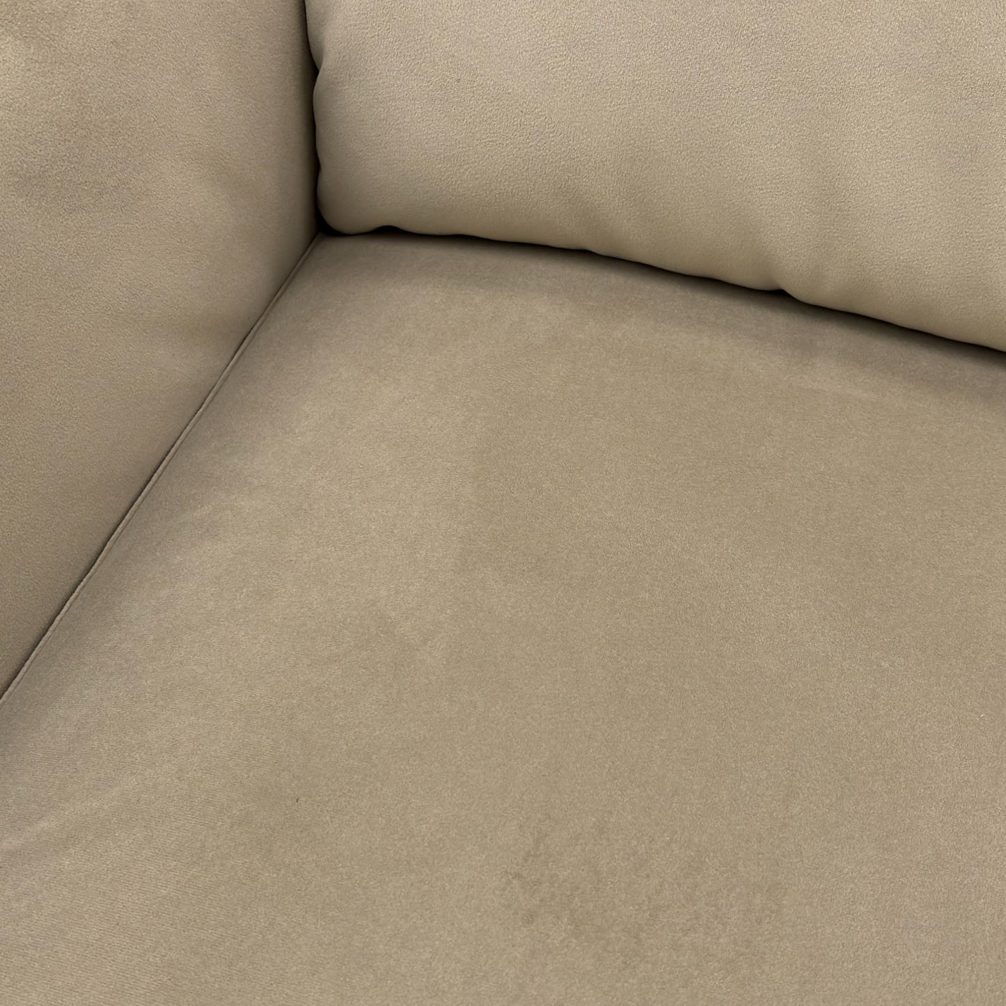 A close-up shot focusing on the texture, stitching, and plush feel of the light khaki velvet fabric.