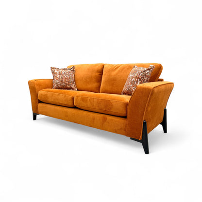 Detailed view of the sofa's back cushions and sloped arm, illustrating the foam filling and medium firmness.