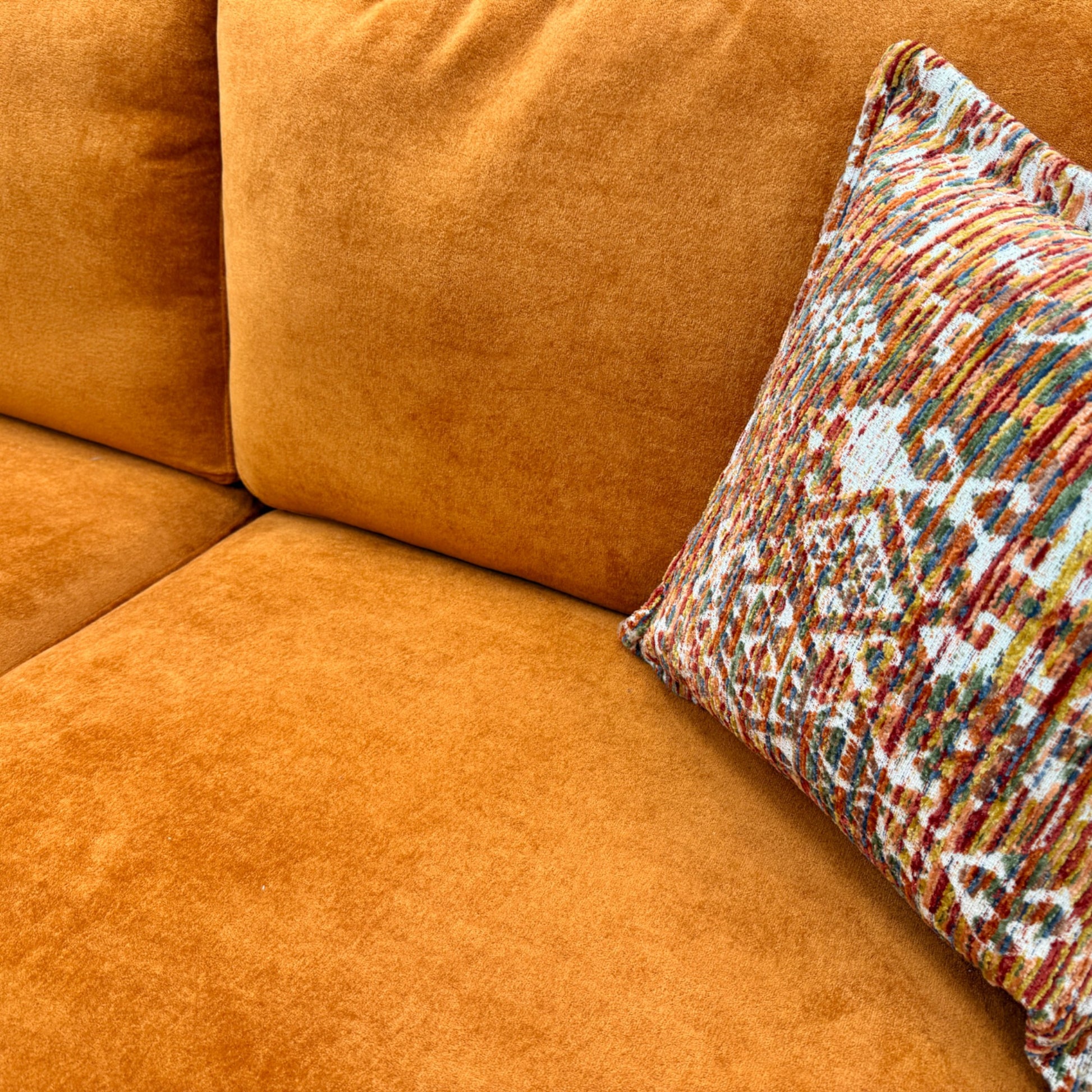 Close-up of the 'towel' texture of the Almond Orange Velvet fabric, showing the soft, distinct pile and color vibrancy.