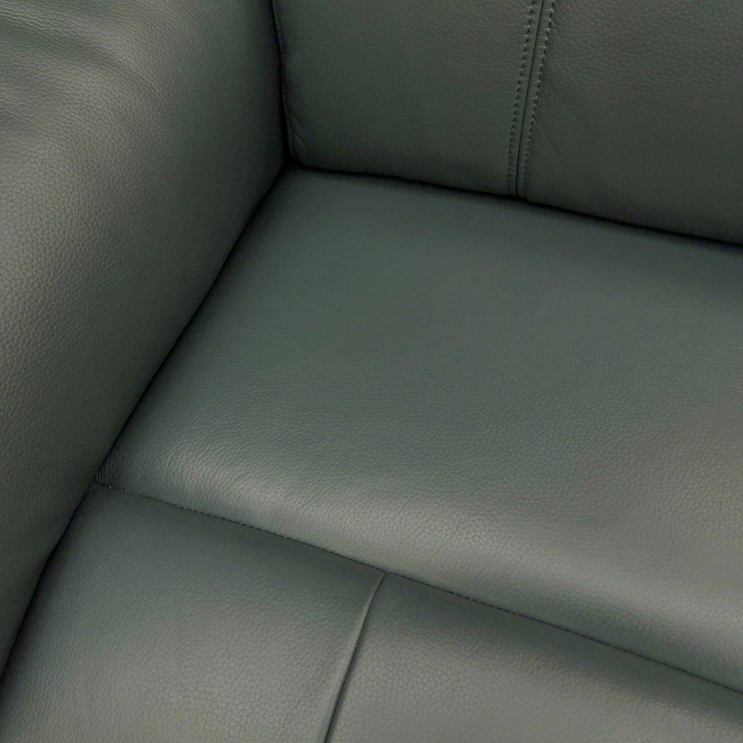 A close-up shot focusing on the high-quality texture and color of the Cat-40:09 Peacock leather.