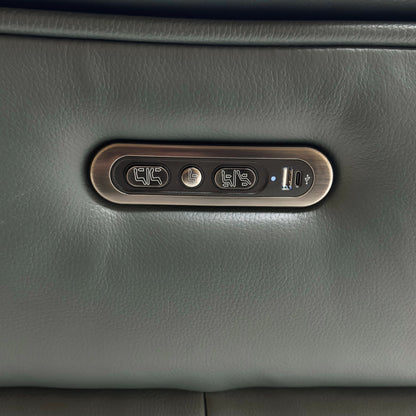A close-up on the end armrest, showcasing the control panel with buttons for the power recline, headrest, and the integrated USB charging port.
