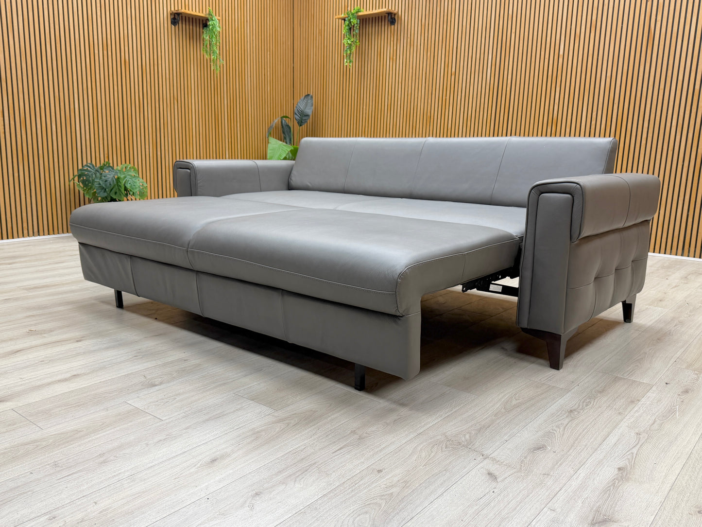 Side view of the Zoom grey leather sofa, emphasizing its streamlined design and space-efficient profile.