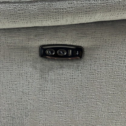 A close-up shot focusing on the armrest, highlighting the power buttons and the integrated USB charging port.