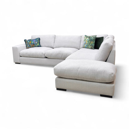 A view focusing on the seat cushions and the stitching detail, or an angle of the open chaise end.