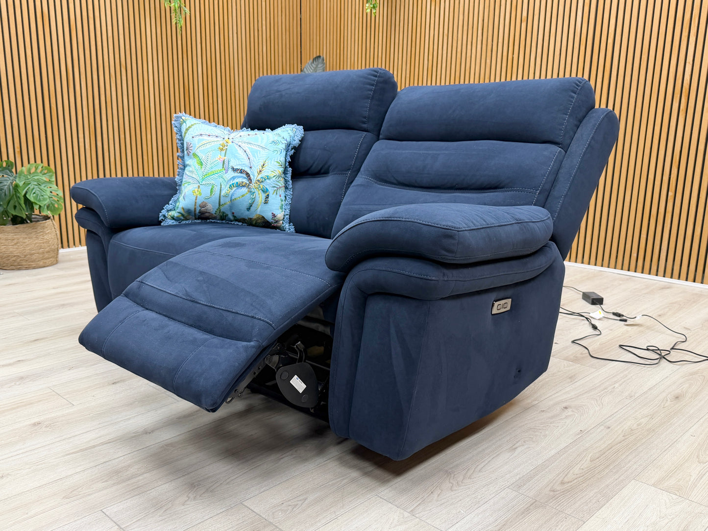 Angle shot of the sofa highlighting the dual power reclining feature and adjustable headrests.