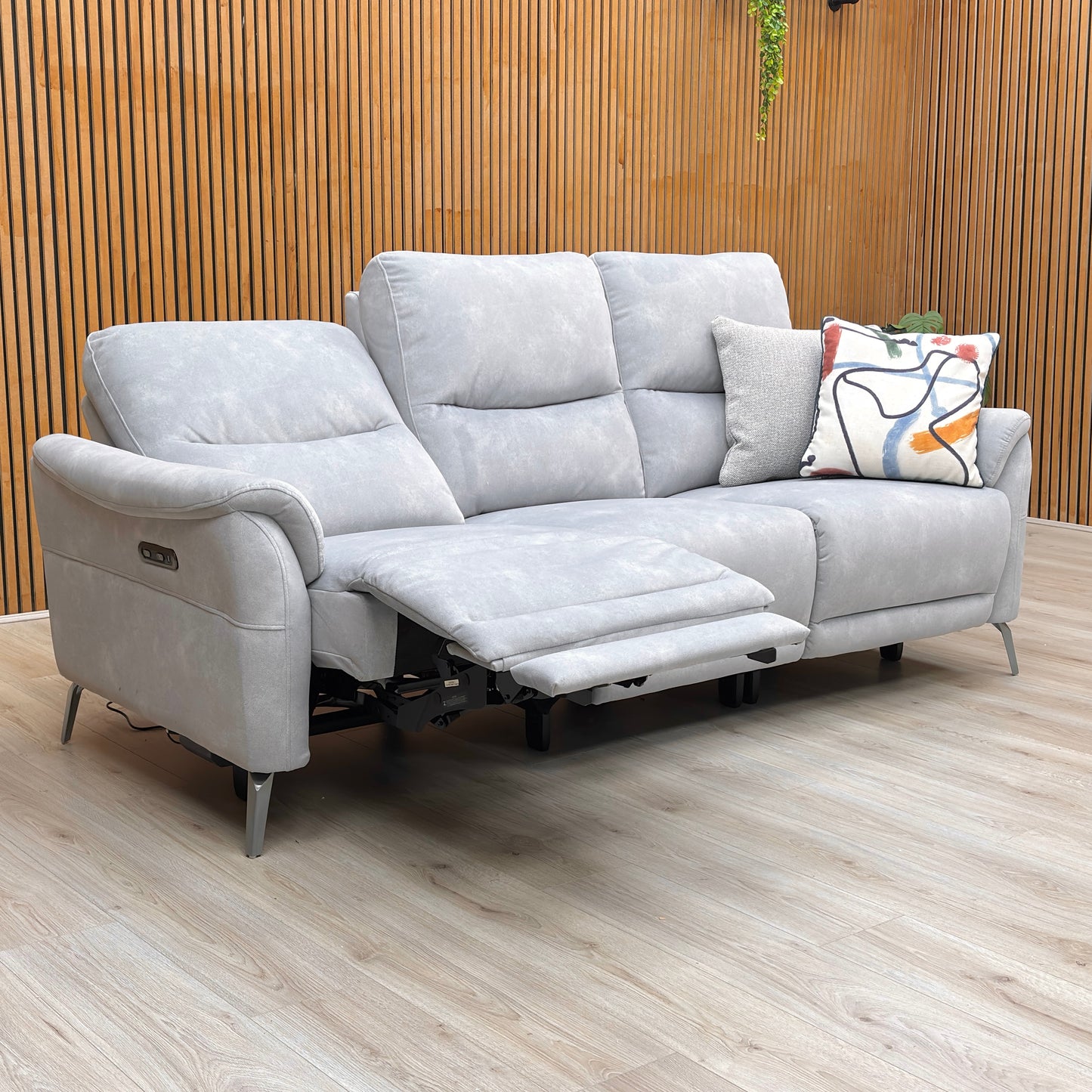 Lifestyle shot of the ‘Dexter’ smoke velvet sofa highlighting the sleek velvet finish and center console.