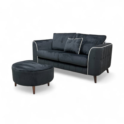 An image showing the overall modern profile of the sofa and footstool, emphasizing the size and sloped armrests.