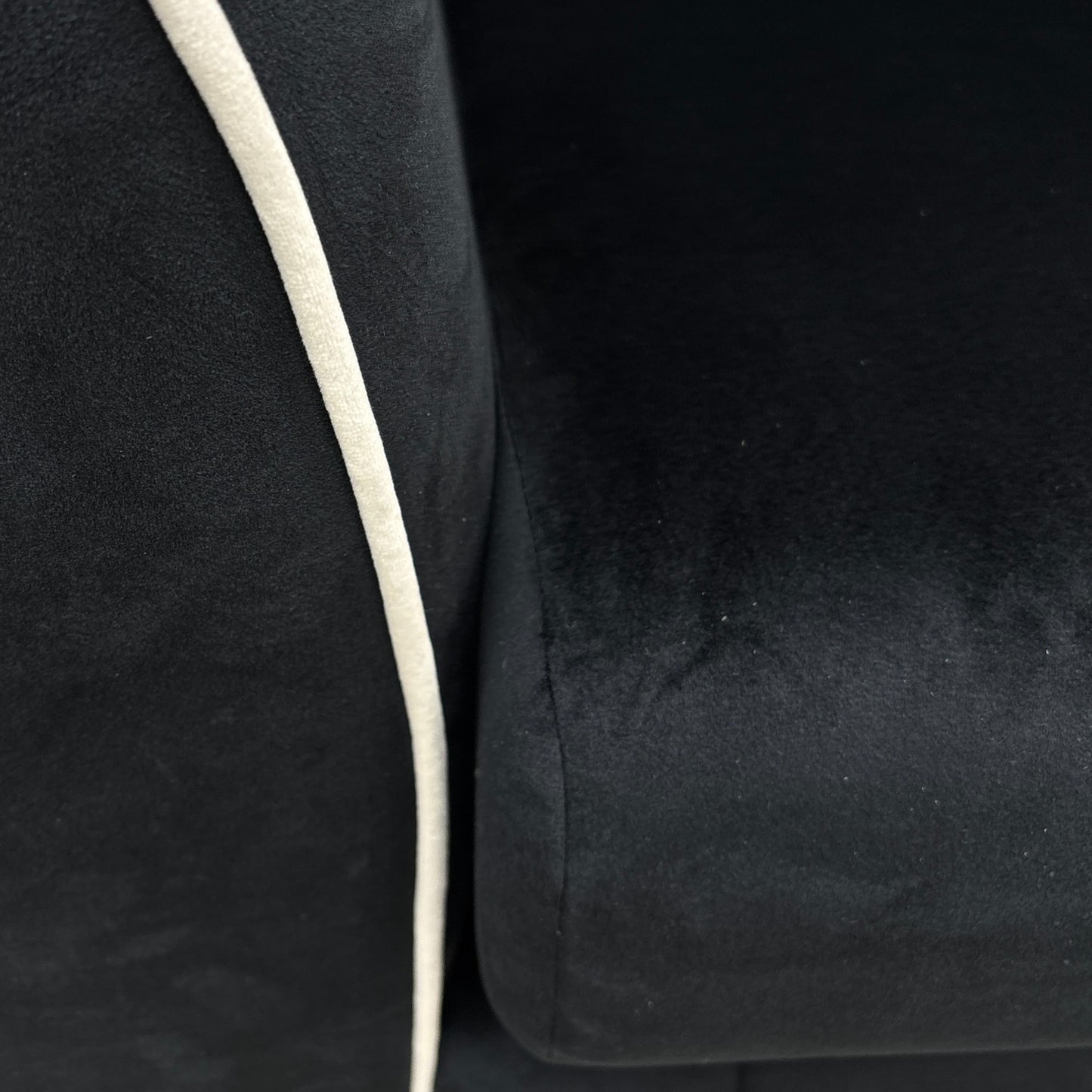 A close-up shot focusing on the shape of the Half Moon Footstool and its use as a continuous extension of the sofa.