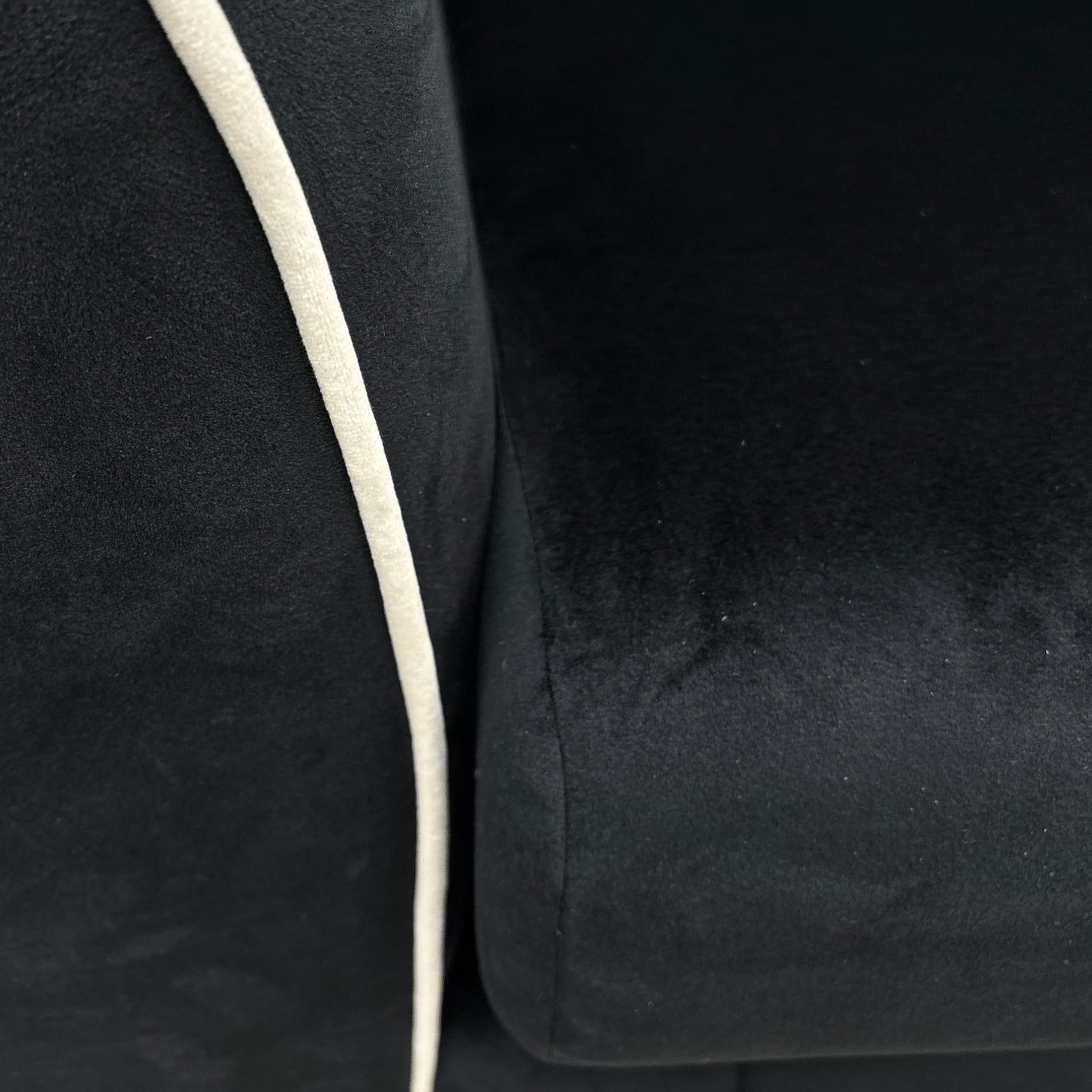 A close-up shot focusing on the shape of the Half Moon Footstool and its use as a continuous extension of the sofa.