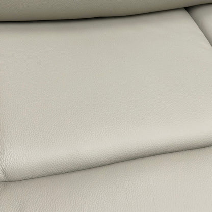 Close-up showing the detail of the Leather texture and stitching on the sofa.