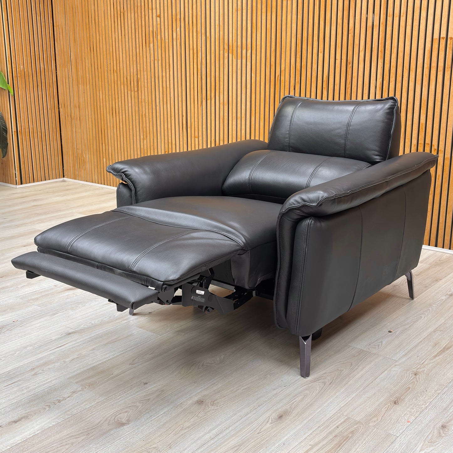 Lifestyle shot of the ‘Jude’ Oslo black leather power recliner chair, highlighting its sleek profile and premium leather finish.