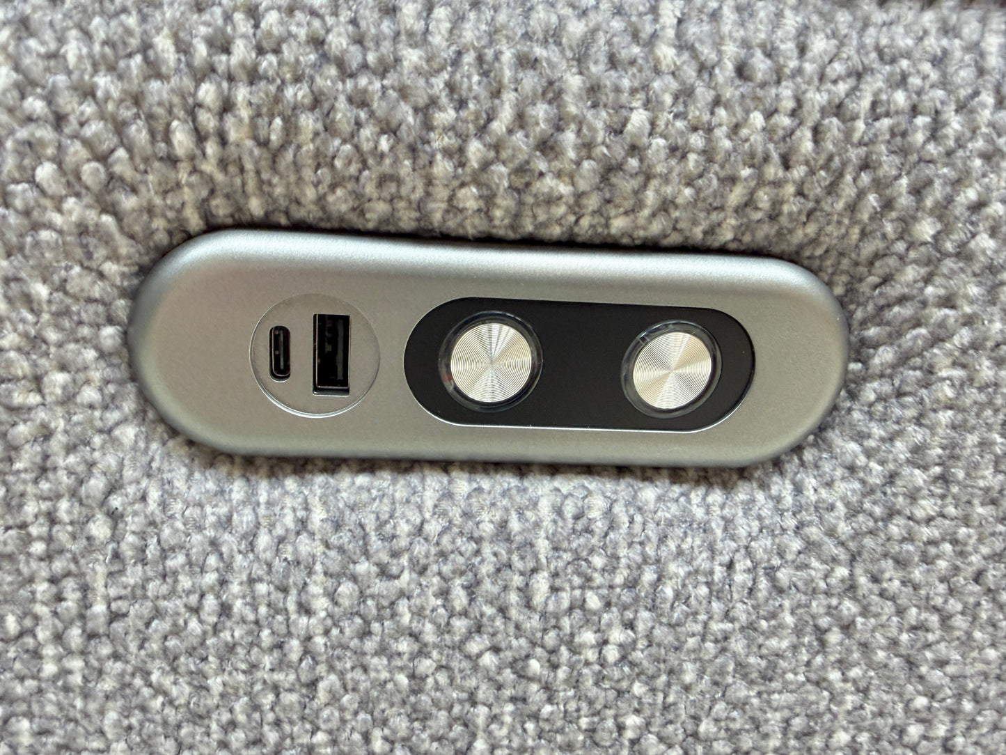 Close-up of the side power control panel, featuring buttons for easy reclining adjustment and integrated USB charging.