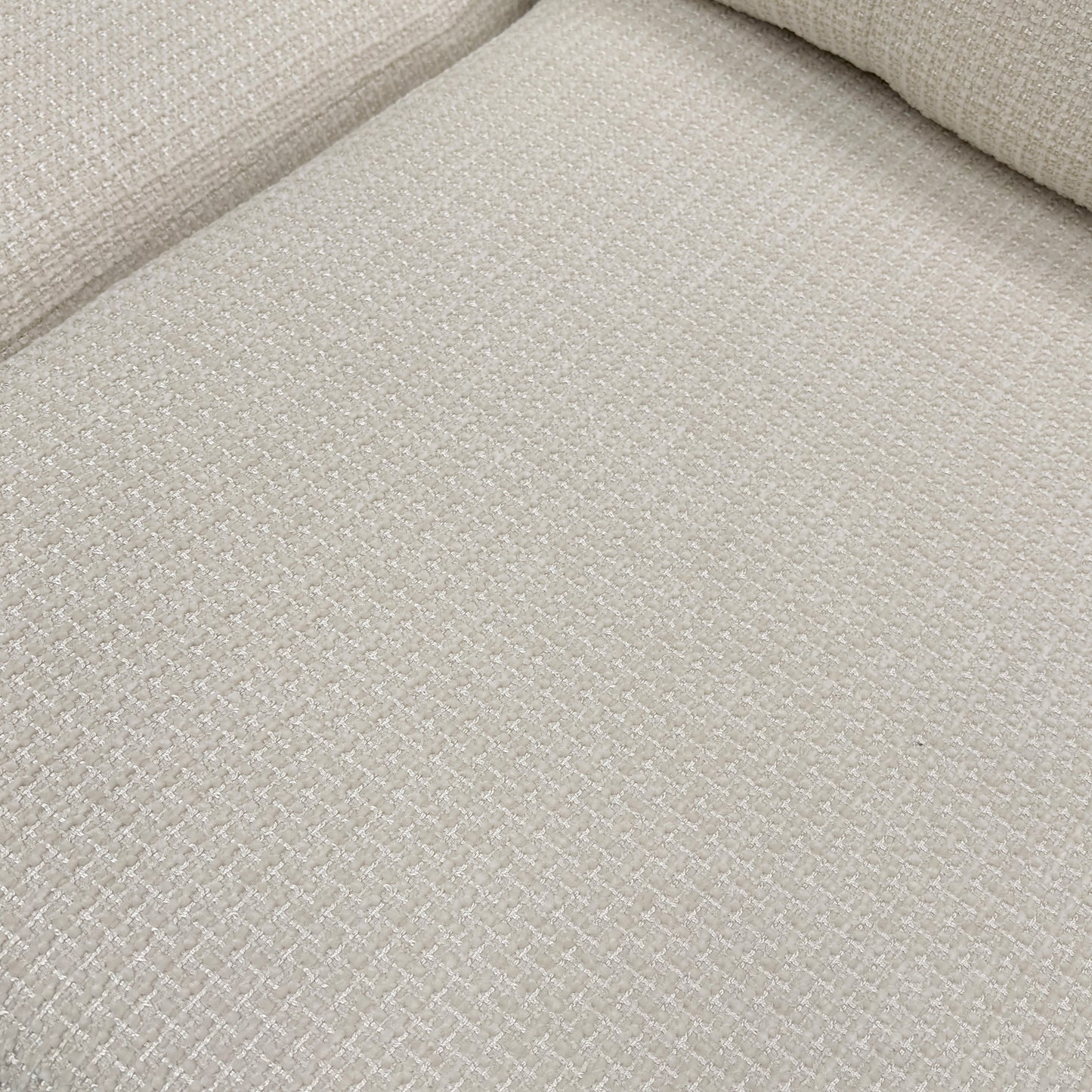 Close-up of the button-back cushions and the texture of the Ivory fabric.