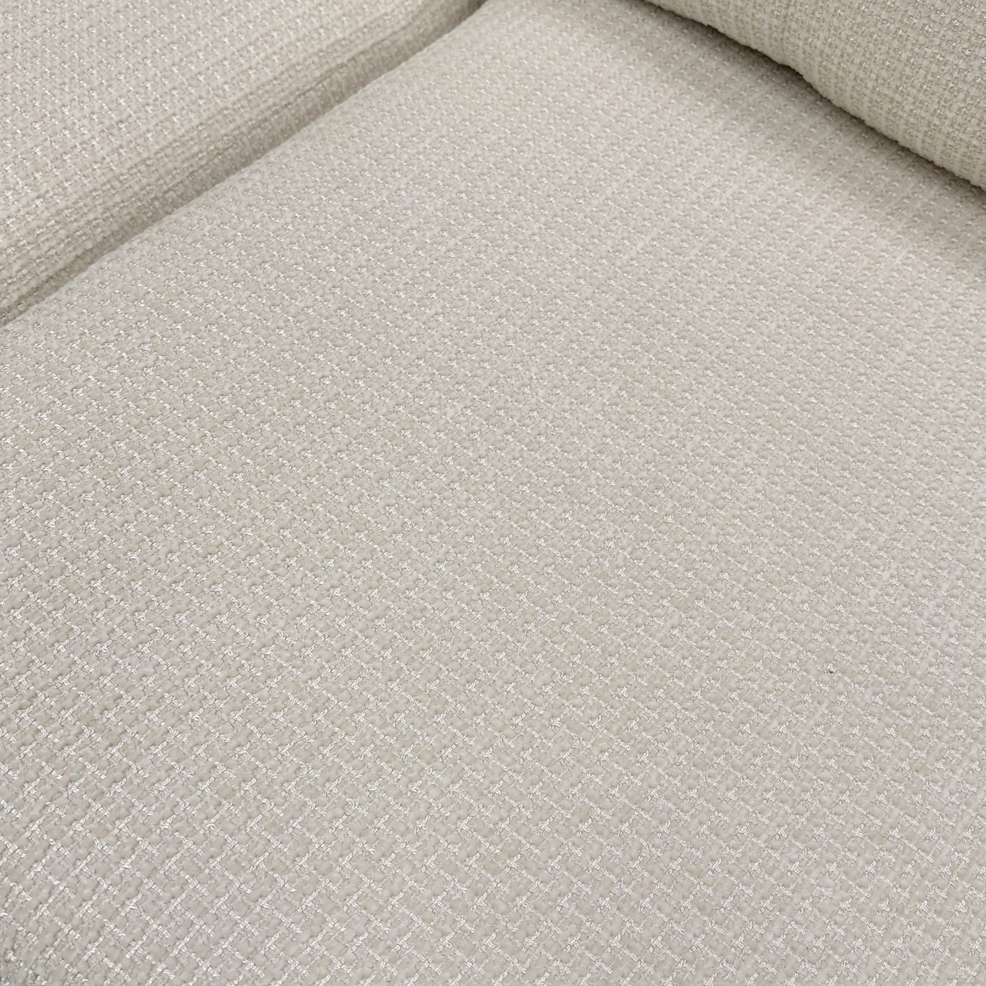Close-up of the button-back cushions and the texture of the Ivory fabric.