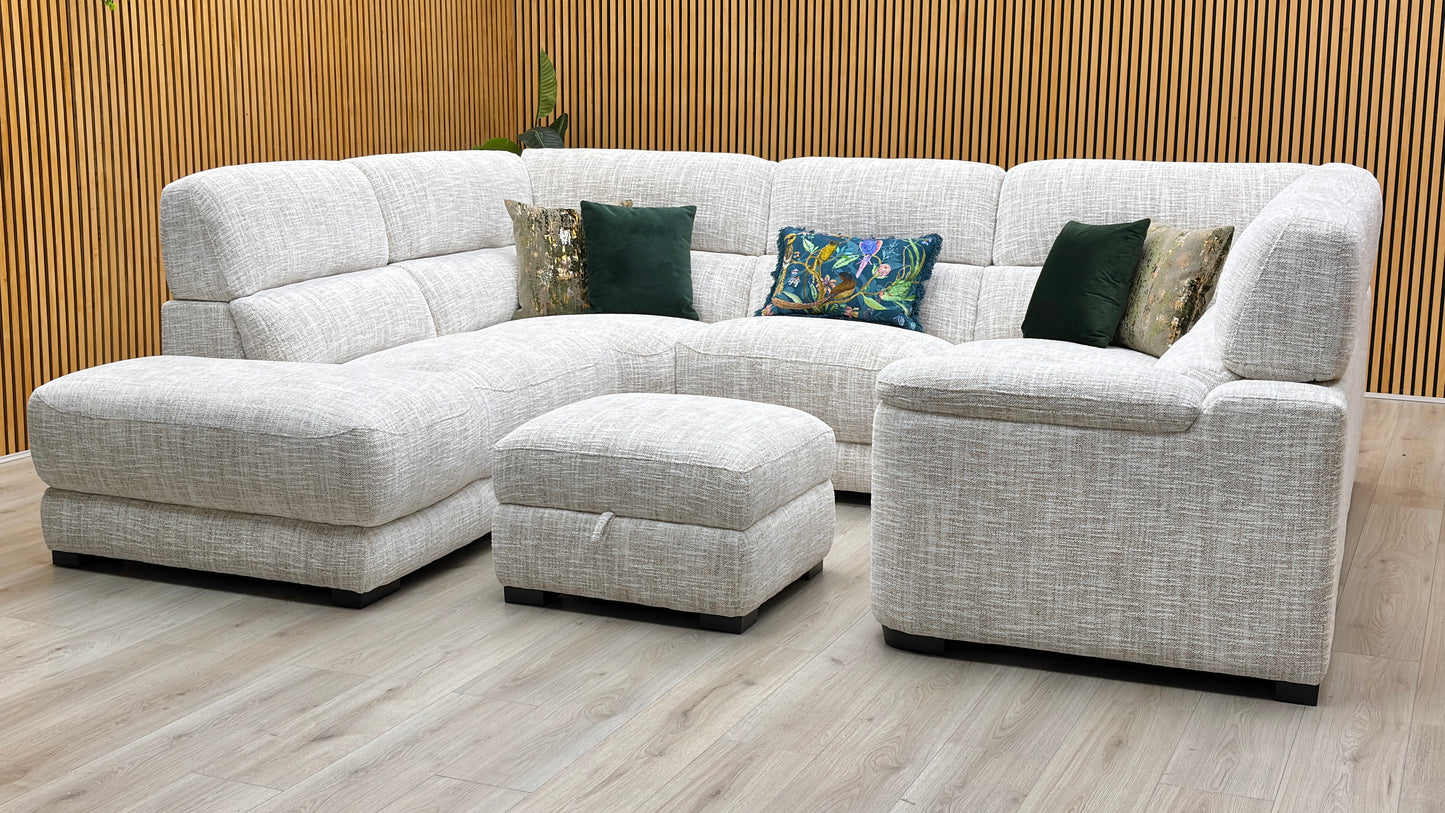 Three-quarter studio perspective showcasing the expansive seating area, supportive low-profile backrest cushioning, and cozy minimalist aesthetic of the suite.
