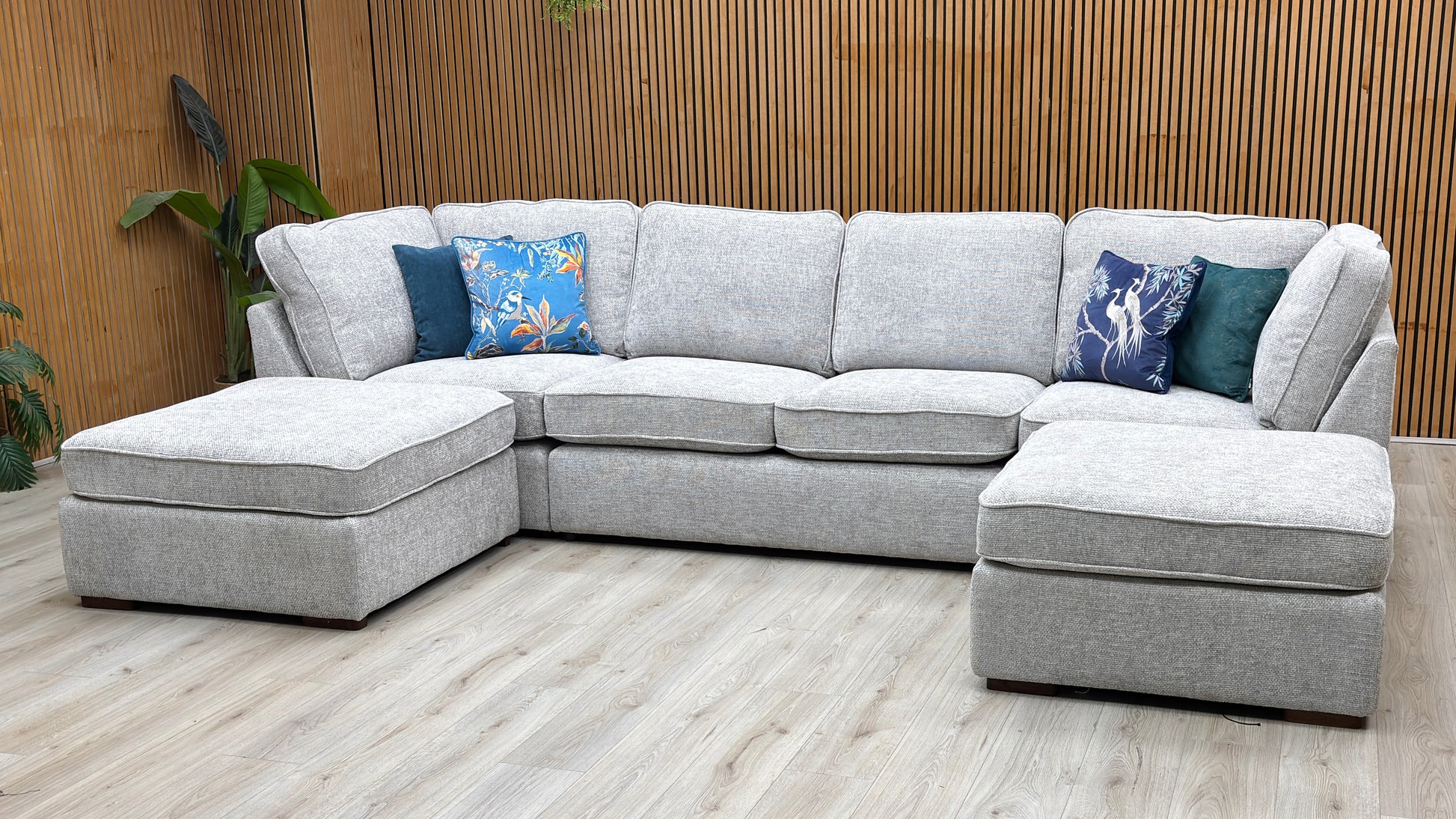 Three-quarter studio perspective showcasing the expansive central lounge area, thick comfort-foam padding, and inviting, cozy mid-century modern aesthetic.