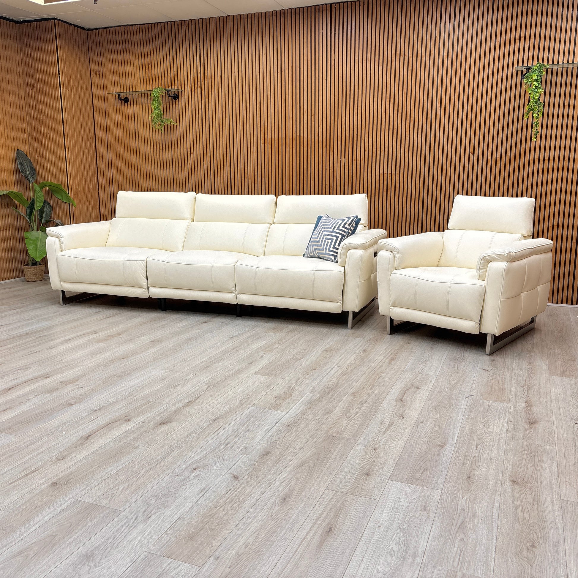Lifestyle view of the Moet 4-seater sofa, showcasing the pristine white leather upholstery, deep bucket seating, and the sophisticated contemporary silhouette.