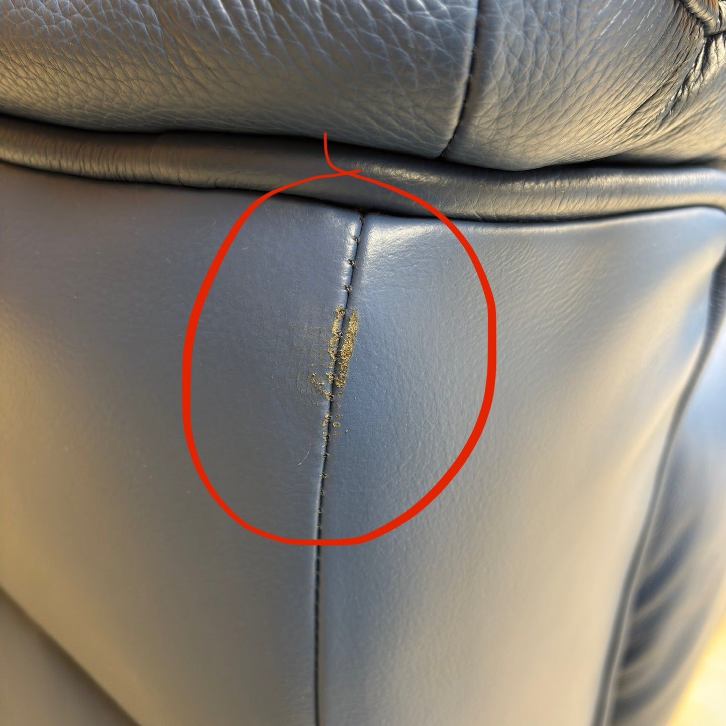 Close-up of a damaged area on the sofa (first damage photo).