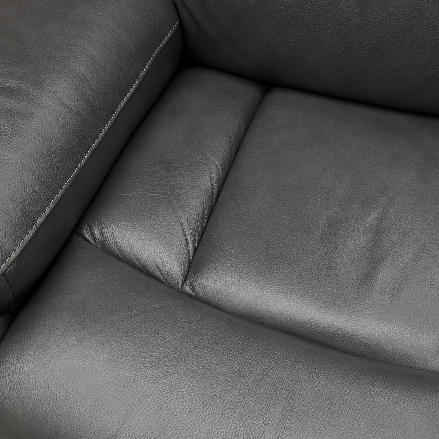 Close-up on the Starry Grey Leather upholstery, showing the texture and color.