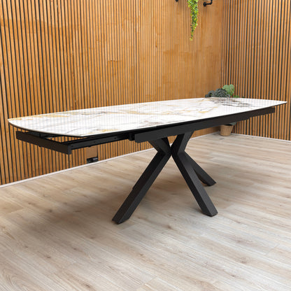 Lifestyle view for the Doro dining table, highlighting the heat, scratch, and stain-resistant ceramic marble surface and the smooth swivel extension mechanism.