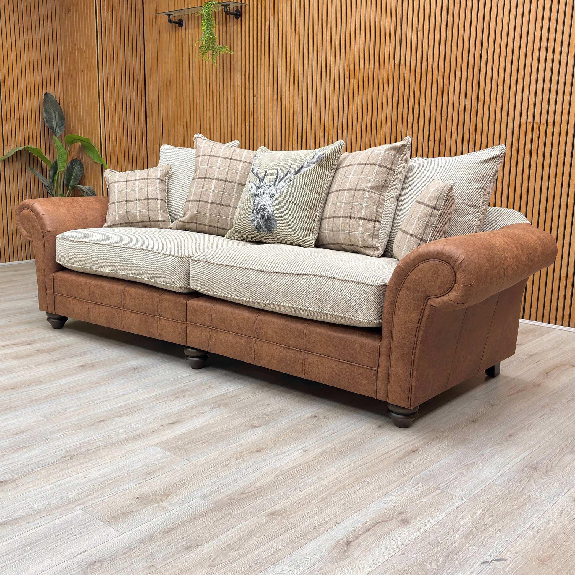 Lifestyle view for the Charles 4-seater sofa, highlighting the neutral Sultan Oatmeal fabric, spacious split-frame design for easy access, and plush scatter cushions.