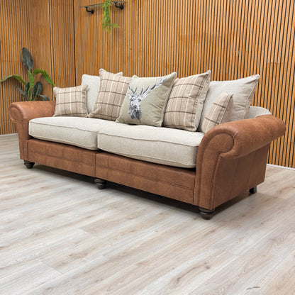 Lifestyle view for the Charles 4-seater sofa, highlighting the neutral Sultan Oatmeal fabric, spacious split-frame design for easy access, and plush scatter cushions.