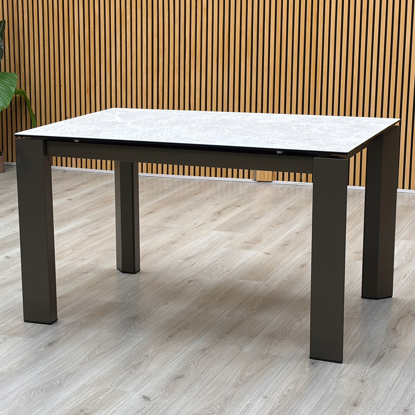 Three-quarter studio perspective showcasing the table mid-extension, demonstrating the precision engineered rotating under-frame mechanism engineered by Italian mastercrafters.