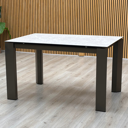 Three-quarter studio perspective showcasing the table mid-extension, demonstrating the precision engineered rotating under-frame mechanism engineered by Italian mastercrafters.