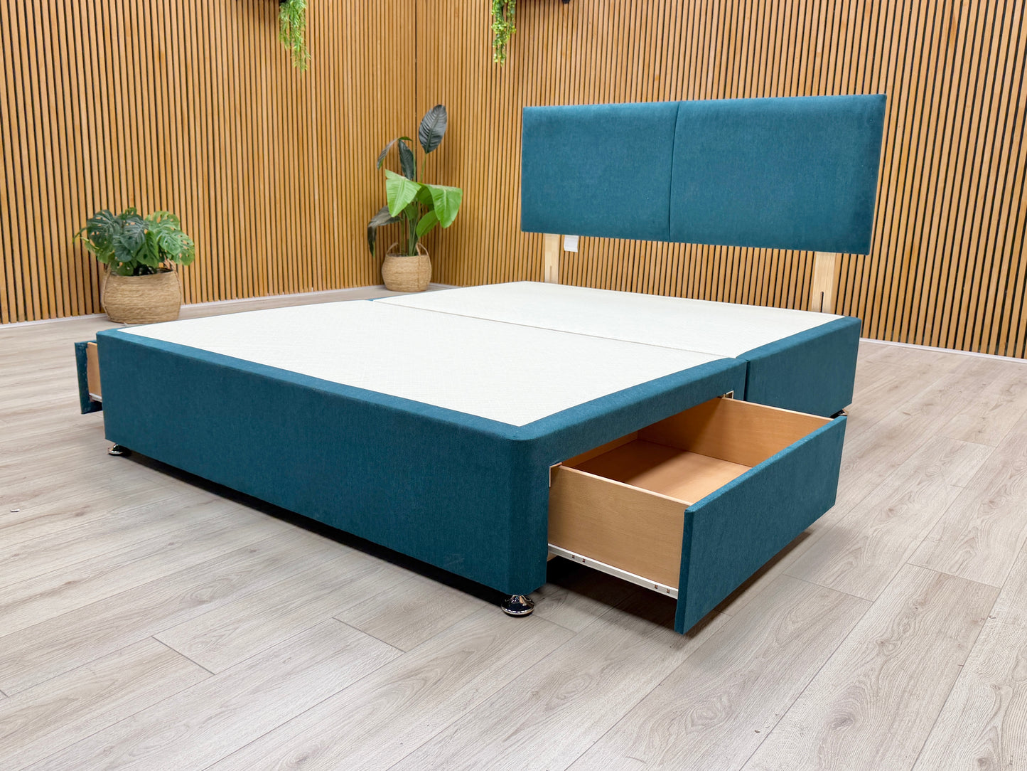 Detail of the two spacious storage drawers built into the side of the king-size divan base, finished in matching Venice New Teal fabric.