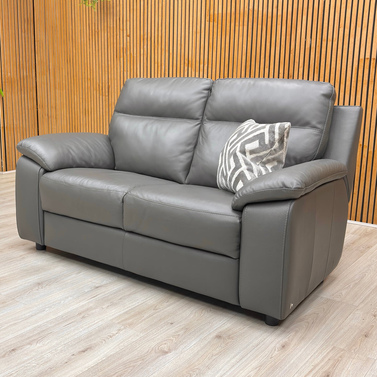 Lifestyle view for the Nicoletti Pepino 2-seater sofa, highlighting the 100% genuine Italian leather, deep bucket seating, and superior craftsmanship.